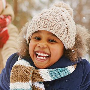 Happy girl playing in the snow